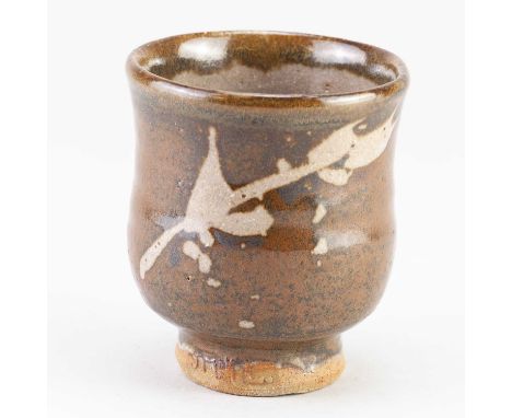 † JIM MALONE (born 1946); a stoneware yunomi covered in tenmoku brealing to kaki glaze with wax resist decoration, impressed 