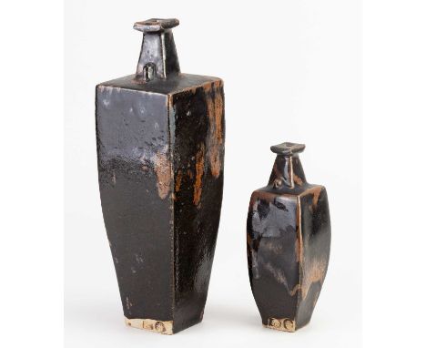 † JOANNA WASON (born 1952) for Leach Pottery; a tapering square stoneware bottle covered in tenmoku breaking to kaki glaze, i