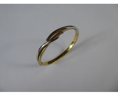 An 18ct Yellow and White Gold Bangle, approx 11.8 gms.
