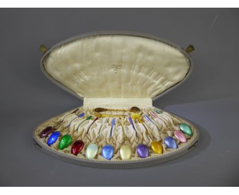 A Set of Twelve Scandinavian Silver Gilt and Enamel Harlequin Teaspoons with matching sugar tongs in a J. Tostrup, 1832, Oslo