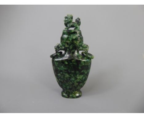 A Qinglong-style Spinach-Green Jade Vase and Cover, having lion-head handles with loose rings to neck, Dog of Fo finial and o