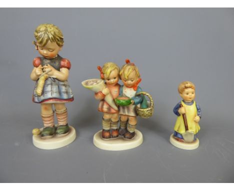 Three Goebel Figurines, including 'Girl with Spade', 'Girl Knitting', 'Bearing Gifts', together with two Nao polar bears, USS