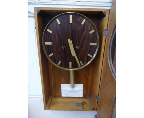 An Art Deco Rosewood and Oak Wall Clock, baton numerals, complete with key, approx 32 x 55 cms