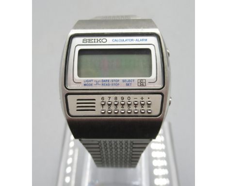 Seiko SQ GW001 LCD stainless steel calculator alarm wristwatch on matching bracelet, signed dial display, signed case back mo