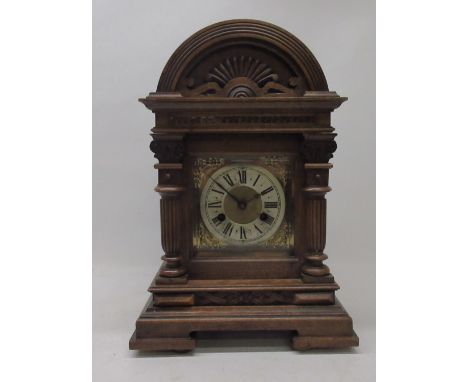 German walnut mantle clock, case having applied moulding, bevel edged glazed panel door enclosing 5 1/2" brass dial with appl