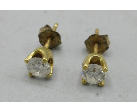 Two 18ct diamond stud earring (not matching pair), with 9ct yellow gold backs, both stamped 750, 0.74gShipping £20.00 plus va