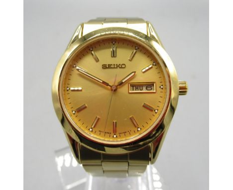 Seiko gold plated quartz wristwatch with day/date on matching bracelet with signed deployment clasp, signed sunburst gold dia