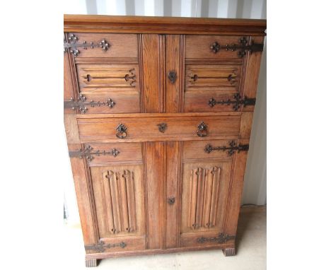 Oak side cabinet, moulded cornice above four linen fold panel doors with brass hinges and a drawer, on block feet, W122cm D50