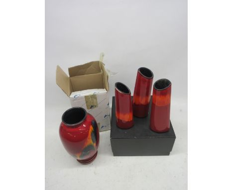 Four Poole Pottery vases; 'Odyssey' style prestige vase complete with original box, H25cm; three flambe glazed tapered-cylind