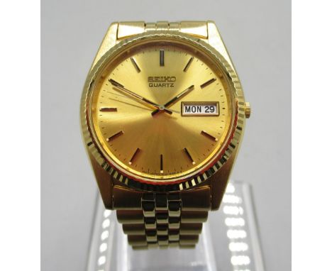Seiko gold plated quartz wristwatch with day/date on matching bracelet with signed deployment clasp, signed sunburst gold dia