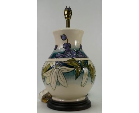 Moorcroft large lamp decorated in the Juneberry design on wood base with shade, height of pottery 28cm