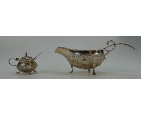 Indian Sterling Silver ornate sauce boat with ladle, decorated with rural Indian scenes and matching ornate covered salt pot 