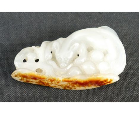 Qing Dynasty (1644-1911) A Chinese white and russet Jade squirrel and grapevine pendant, length 3.8cm