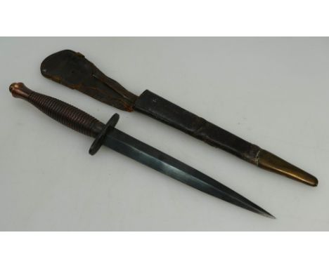 Fairbairn Sykes fighting knife in original leather scabbard (some wear to leather handle grip area), overall length 33cm