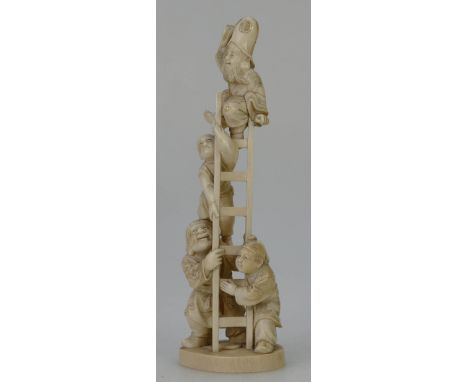 A Japanese carved ivory okimono figure group of two men holding a ladder and two men climbing the ladder, height 21cm, Meiji 