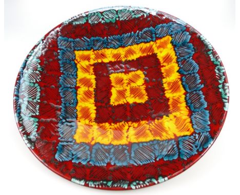 Large Poole Studio ware charger signed Janice Tchalemko to rear, decorated in abstract design with red, orange and blue colou