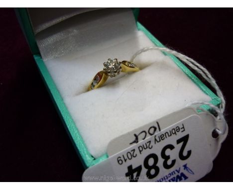 An 18ct diamond solitaire with diamond side Ring.