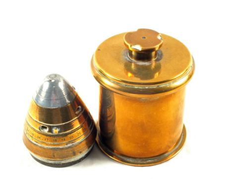A German 'Trench Art' tobacco jar, base shell dated 1915, lid shell dated 1912 together with shell head timer/fuse