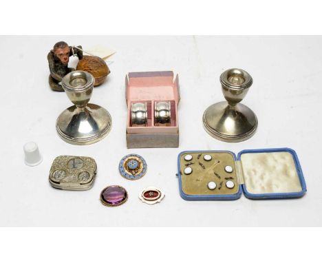 Cold painted spelter inkwell of a monkey sitting with a walnut; a 9ct yellow gold and red enamel brooch; two other brooches; 