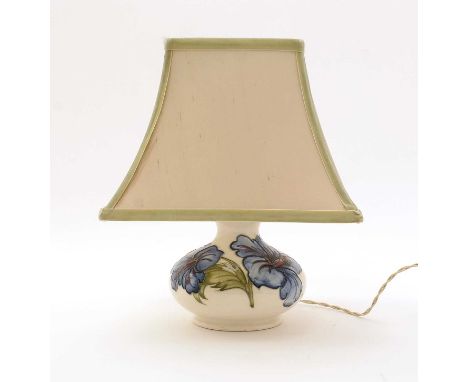 A Moorcroft Hibiscus pattern table lamp, decorated with blue flowers on a cream glazed ground, impressed marks, paper label, 
