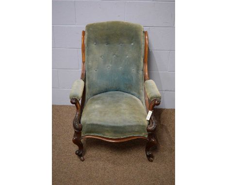 A Victorian carved mahogany and button back open armchair, with scroll back and armrests, squat cabriole legs, on castors, 72