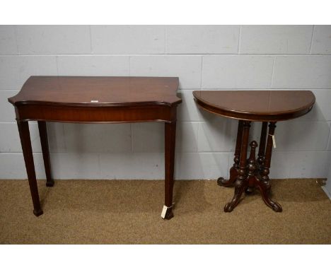 A Georgian-style reproduction mahogany serpentine card table, the top with fluted border and opening on gate legs to reveal a