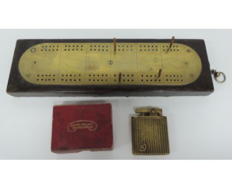 An early 20th Century novelty musical cigarette lighter in brass case and in box for James Walker, Jeweller and together with
