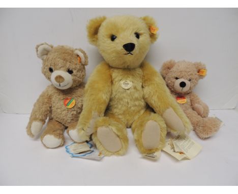 A modern Steiff classic Teddy Bear with golden plush and with all labels, 43cms high together with two other smaller modern S