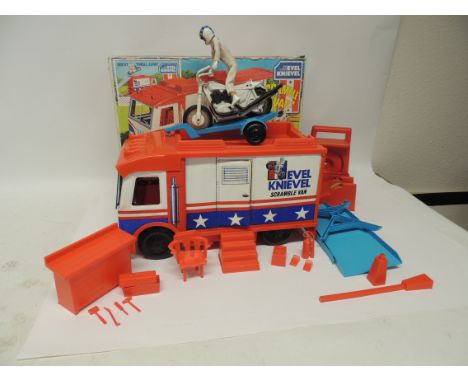 An Ideal Evel Knieval Scramble Van with jump ramp, bike trailer, workshop, tools, fire extinguisher, chair and other accessor