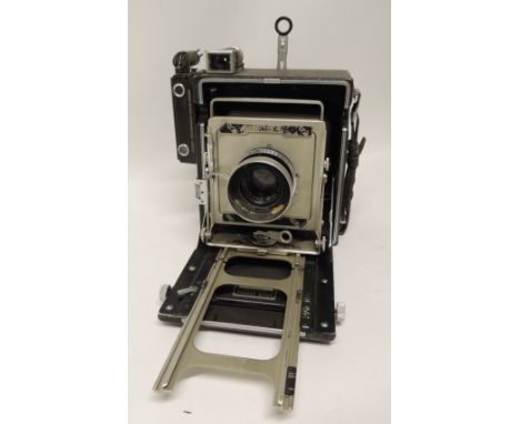 A Graflex Speed Graphic folding camera with 135mm 4.7 lens, Rapax shutter, serial number 839736  in original carrying case to