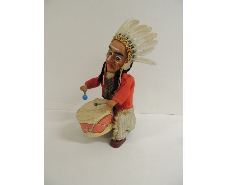 An Alps (Japan) battery operated toy Red Indian playing a drum, with original clothing and plastic head-dress, 30cms high