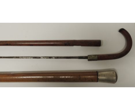 A late 19th/early 20th Century swordstick, the narrow tapering blade in malacca case with curved wood handle, 91cms long and 