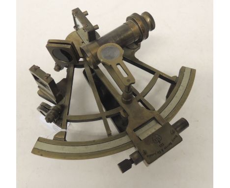 An early 20th Century sextant by Henry & Barrow Co London having white metal engraved scale, brass frame and wood handle, unb