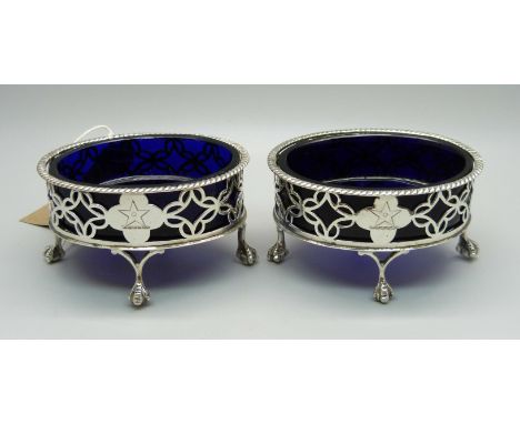 A pair of Victorian silver salt cellars with blue glass liners, London 1884, weight of bases 98g 