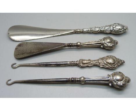 Two silver mounted shoe horns and two button hooks 