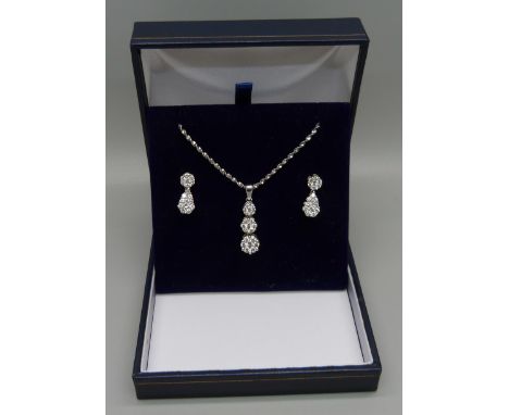 A 14ct white gold and diamond triple cluster drop pendant and chain and matching earrings (silver scrolls), approximately 1.5