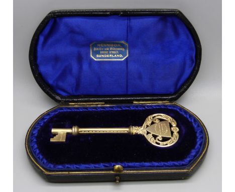 A silver gilt key in original fitted case, Birmingham 1911, with inscription, 43g 