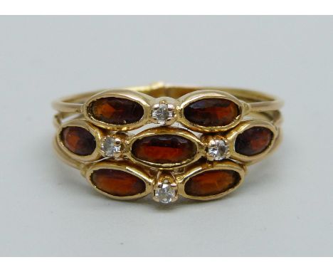 An 18ct gold and garnet ring, marks to back of shank, 3.6g, T 