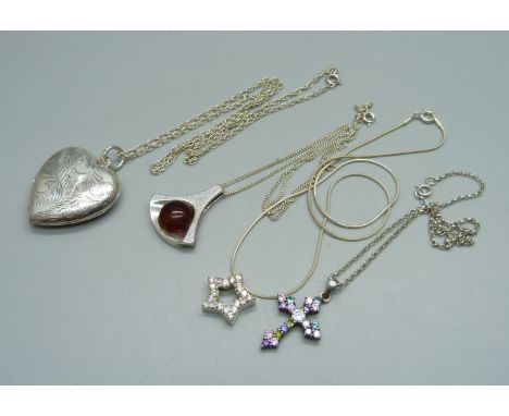 A silver locket and chain and three silver pendants and chains, 28g 