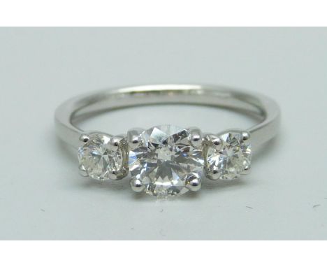 A platinum and three stone diamond ring, marked Plat, total diamond weight 1.14ct, (centre diamond 0.72ct), 3.7g, M 