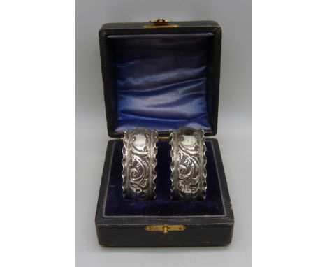 A pair of Victorian silver napkin rings in fitted case, Birmingham 1896, inscription erased 