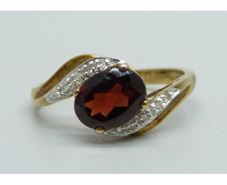 A 9ct gold, garnet and diamond crossover ring, 2.8g, S 