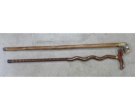 Two walking canes including one with glass drinking flask 