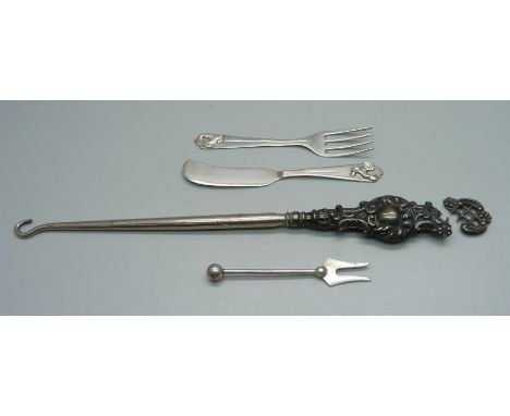 A small continental silver knife and fork with cockerel motif to handle, a silver pickle fork and a silver handled button hoo