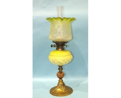 A Victorian brass and copper oil lamp with moulded pale green glass reservoir and etched glass shade, 63cm high. 