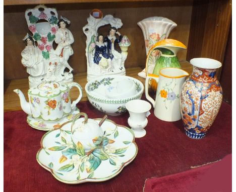 A Victorian Staffordshire flat-back figural spill vase of a courting couple, 27.5cm high, another as a watch holder, 31.5cm h