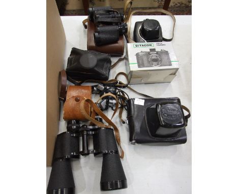 A Zenit-E 35mm camera in case, a Halina camera, other cameras, a pair of Milo 7 x 18 field glasses and other binoculars. 