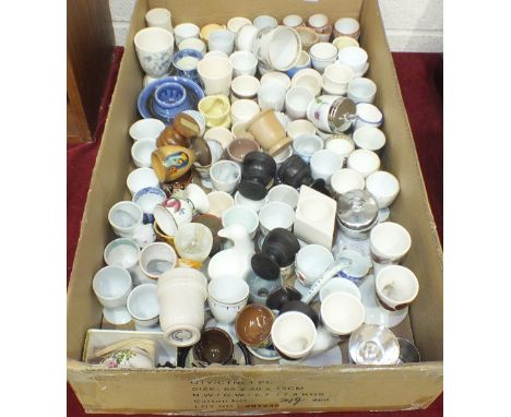 A collection of approximately one hundred various ceramic, wooden and other egg cups. 