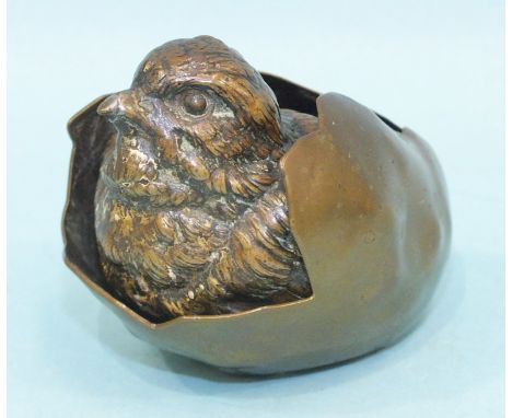 An Austrian cold-painted bronze chick emerging from an egg, marked Geschutz, 5cm high, 6cm long. 