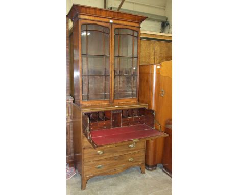 A Georgian-style mahogany small secretaire with fitted writing drawer above three cockbeaded drawers, on splayed bracket feet